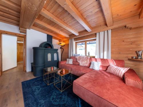 a living room with a red couch and a stove at City Hide-Away in Kitzbühel