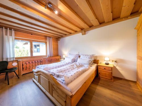 a bedroom with a large bed with a wooden ceiling at City Hide-Away in Kitzbühel