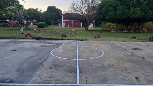 a basketball hoop in the middle of a park at HOTEL CAMPESTRE CRISTALES cerca al mar By AMAUNA in San Bernardo del Viento