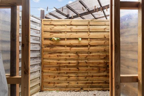 a wooden privacy fence in a house at Anapa Beach House in Temae