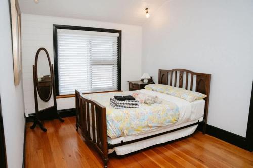 a bedroom with a bed and a window with a window at Saltwood Peterborough in Peterborough