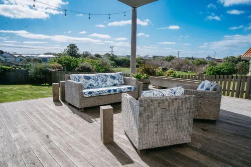 a patio with two chairs and an umbrella at Saltwood Peterborough in Peterborough