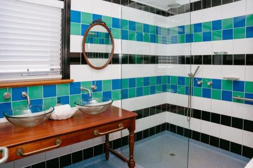 a bathroom with two sinks and a shower at Saltwood Peterborough in Peterborough