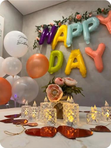 a table with a happy day sign and balloons at Lala Posh#수원#삼성전자#행궁동#2룸 in Seryu-dong