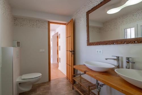 a bathroom with two sinks and a mirror at Casa Cobalto, Sea view, Mediterranean, Sea 700meters, 4 Bedrooms in Benissa