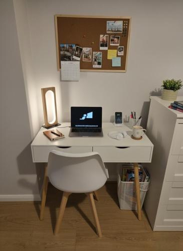 a white desk with a laptop and a chair at Chalfont Haven 