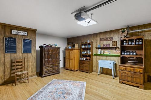 a room with wooden walls and a shop with wooden furniture at Lodge Apartment at Owl Creek Farm Resort in Murphy