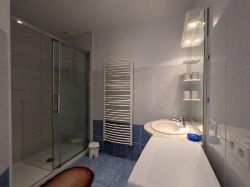 a white bathroom with a shower and a sink at Gîte à la montagne avec cheminée, wifi et joli terrain - FR-1-589-179 in Le Tholy