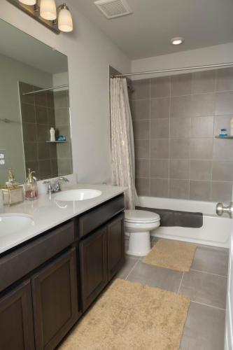 a bathroom with a sink and a toilet and a mirror at Private Room in Richmond, TX in Richmond