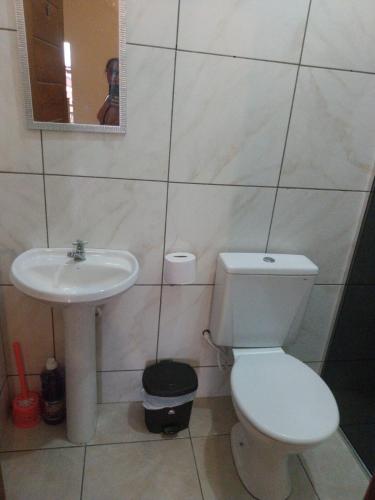 a bathroom with a toilet and a sink at Apt Raphis D in Santarém