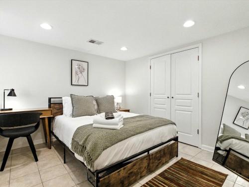 a bedroom with a bed and a desk and a chair at Cozy 2BR Flat - Walk to METRO Union Market in Washington