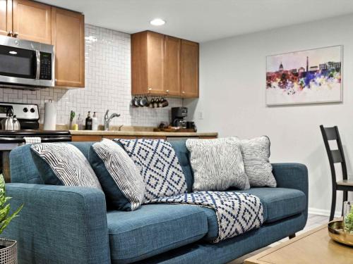 a living room with a blue couch in a kitchen at Cozy 2BR Flat - Walk to METRO Union Market in Washington