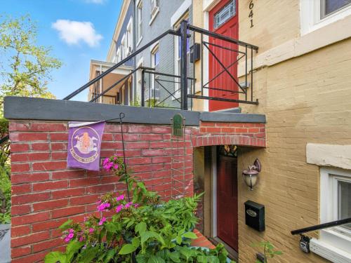 a red brick building with a flag on it at Cozy 2BR Flat - Walk to METRO Union Market in Washington