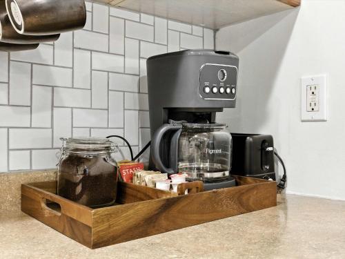 a coffee maker in a wooden tray on a counter at Cozy 2BR Flat - Walk to METRO Union Market in Washington