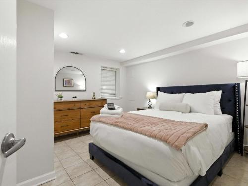 a bedroom with a large bed and a bathroom at Cozy 2BR Flat - Walk to METRO Union Market in Washington