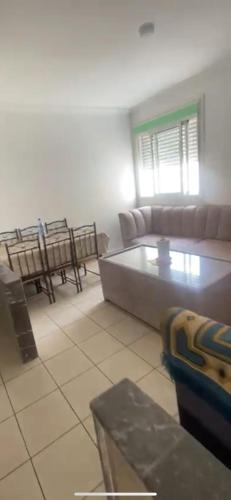 a living room with a couch and a table at Alyons in Fnidek