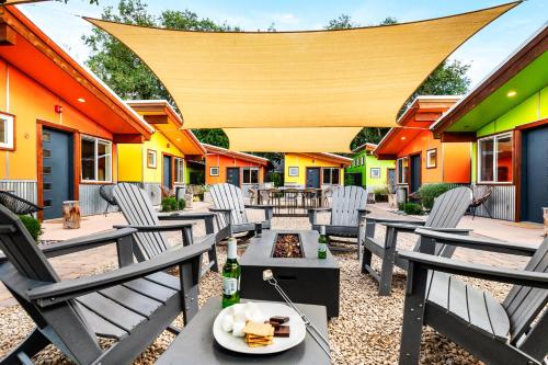 an outdoor patio with chairs and a fire pit at Downtown Kokopelli West 9 - Newly Remodeled Stylish Studio in Moab