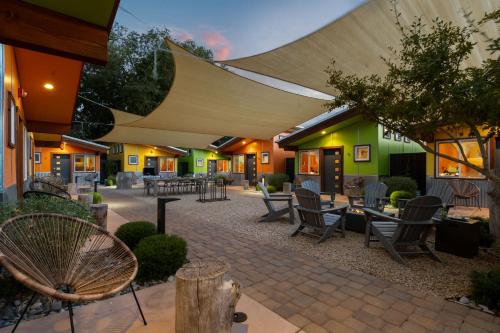 a patio with chairs and tables in a building at Downtown Kokopelli West 9 - Newly Remodeled Stylish Studio in Moab