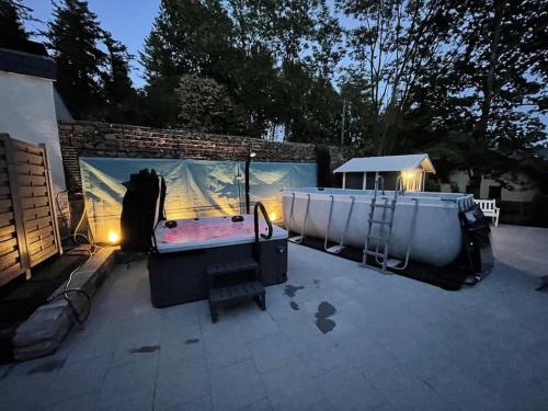 a backyard with a hot tub and a jacuzzi at Sweden with sauna in Kleinweidelbach