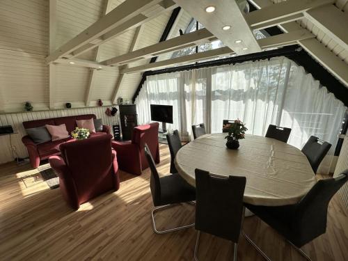 a room with a table and chairs and a couch at Sweden with sauna in Kleinweidelbach