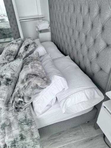 an unmade bed with a dog laying on it at Hotel Casa Blanca in Aguadas