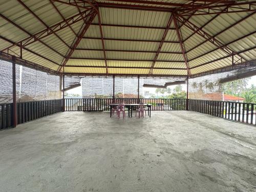 a large room with tables and benches in a building at Cris&Mar Homestay Extension in Burgos
