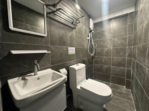 a bathroom with a toilet and a sink at SS GREY INN Bb in Kuala Lumpur
