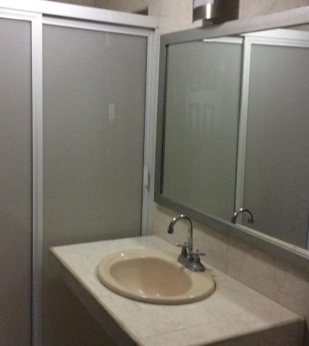 a bathroom with a sink and a mirror at Suites Atlas - Ocean Front in Bucerías