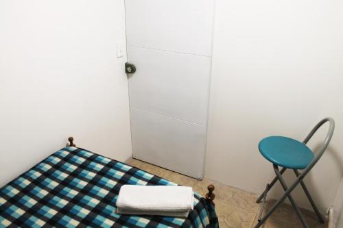 a room with a table and a chair and a door at Casa Posada Amelia in Bogotá