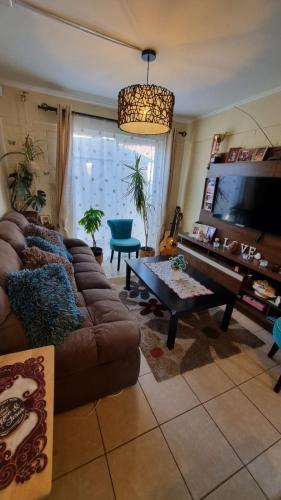 a living room with a couch and a table at Habitación 2 personas casa familiar sector residencial in Coquimbo