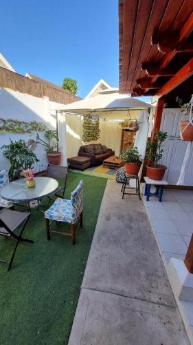 a patio with a table and chairs and an umbrella at Habitación 2 personas casa familiar sector residencial in Coquimbo