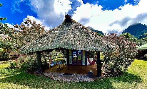 a small hut with a grass roof at Linareva Moorea Beach Resort in Haapiti