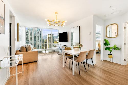 a living room with a table and chairs and a couch at Best Location Downtown Chic Suites in Vancouver