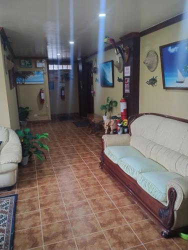 a living room with two couches and a tile floor at Sailfishbay Surf And Big Game Fishing Lodge in San Isidro