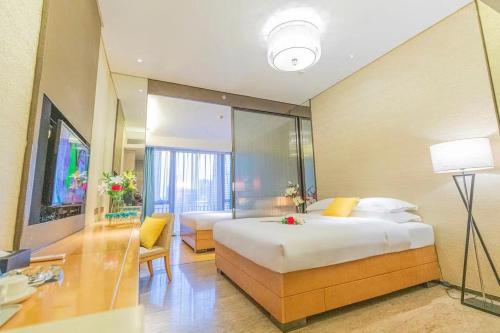 Ein Bett oder Betten in einem Zimmer der Unterkunft Yizhimei Light Residence