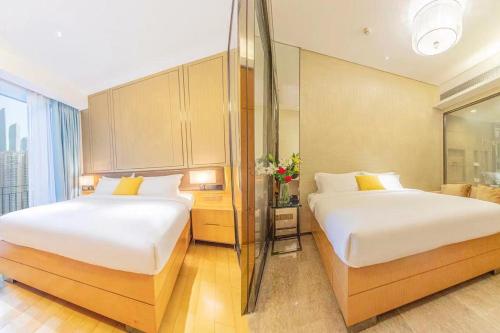 Ein Bett oder Betten in einem Zimmer der Unterkunft Yizhimei Light Residence