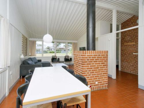 a living room with a table and a brick wall at Seaside Bliss in Gilleleje-By Traum in Smidstrup