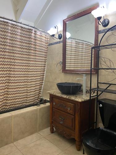 a bathroom with a sink and a mirror at Sxm Paradise Town House in Marigot