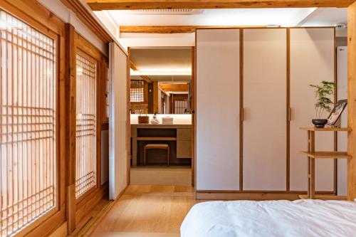 a bedroom with a sliding door leading to a bathroom at Gyedong Hanok 125 in Seoul