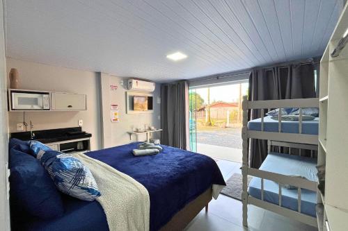 a bedroom with a bed and a bunk bed at Vaz Beach Residence in Penha
