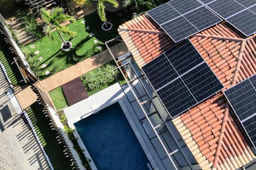 an overhead view of a house with solar panels on the roof at Pousada Pedra da Pipa in Pipa