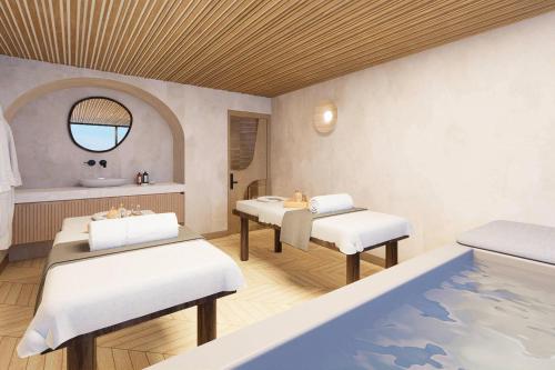 a spa room with two beds and a tub at Faranda Collection Cartagena, a member of Radisson Individuals in Cartagena de Indias