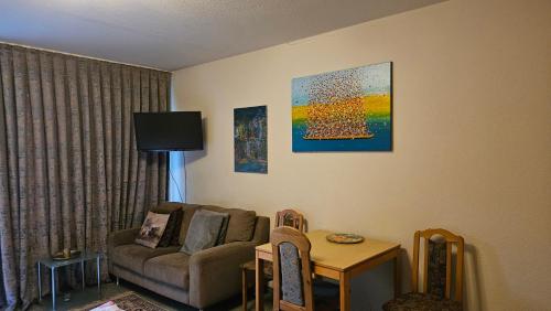 a living room with a couch and a table at Appartement an der Weinstraße Bad Bergzabern in Bad Bergzabern