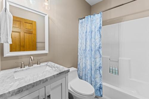 a bathroom with a toilet and a sink and a shower at Ma Cook Lodge - Sharps Chapel in Maynardville