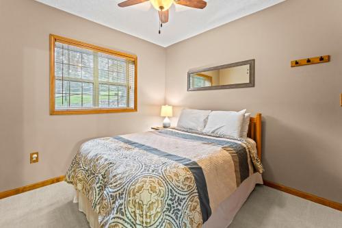 a bedroom with a bed and a ceiling fan at Ma Cook Lodge - Sharps Chapel in Maynardville