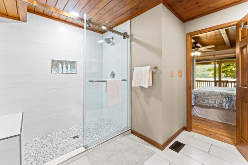 a bathroom with a shower with a glass door at Ma Cook Lodge - Sharps Chapel in Maynardville