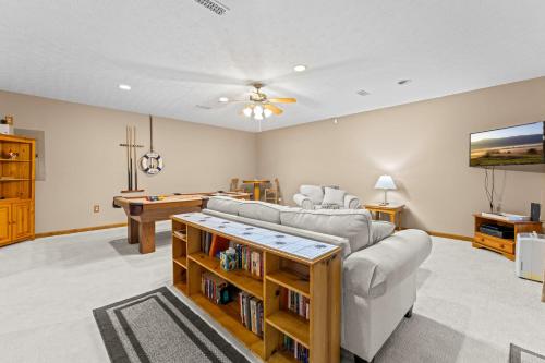 a living room with a couch and a pool table at Ma Cook Lodge - Sharps Chapel in Maynardville