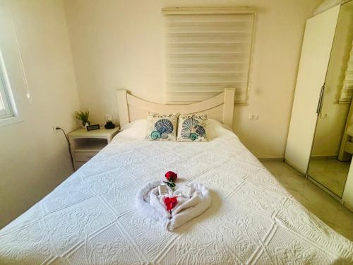 a bed with a heart made out of towels on it at Beachfront Studio, fully equipped in Netanya