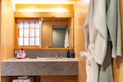 a bathroom with a sink and a mirror at Gyedong Hanok 125 in Seoul