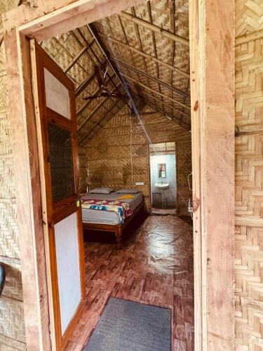 a bedroom with a bed in a room at Murali Guesthouse Hampi in Hampi